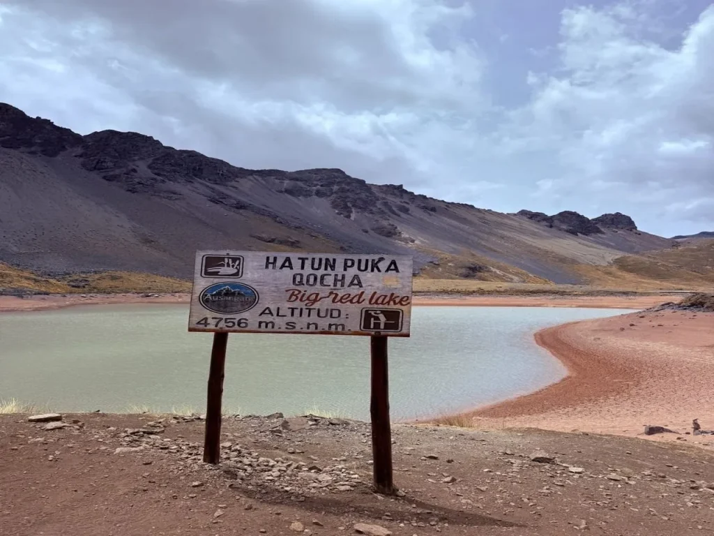 Hatun Puka Qocha, the red lake of the 7 Lakes of Ausangate hike in Cusco, Peru