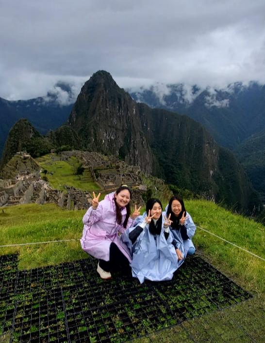 Best time to visit Machu Picchu with travelers enjoying panoramic views of the Inca citadel during the dry season in Peru