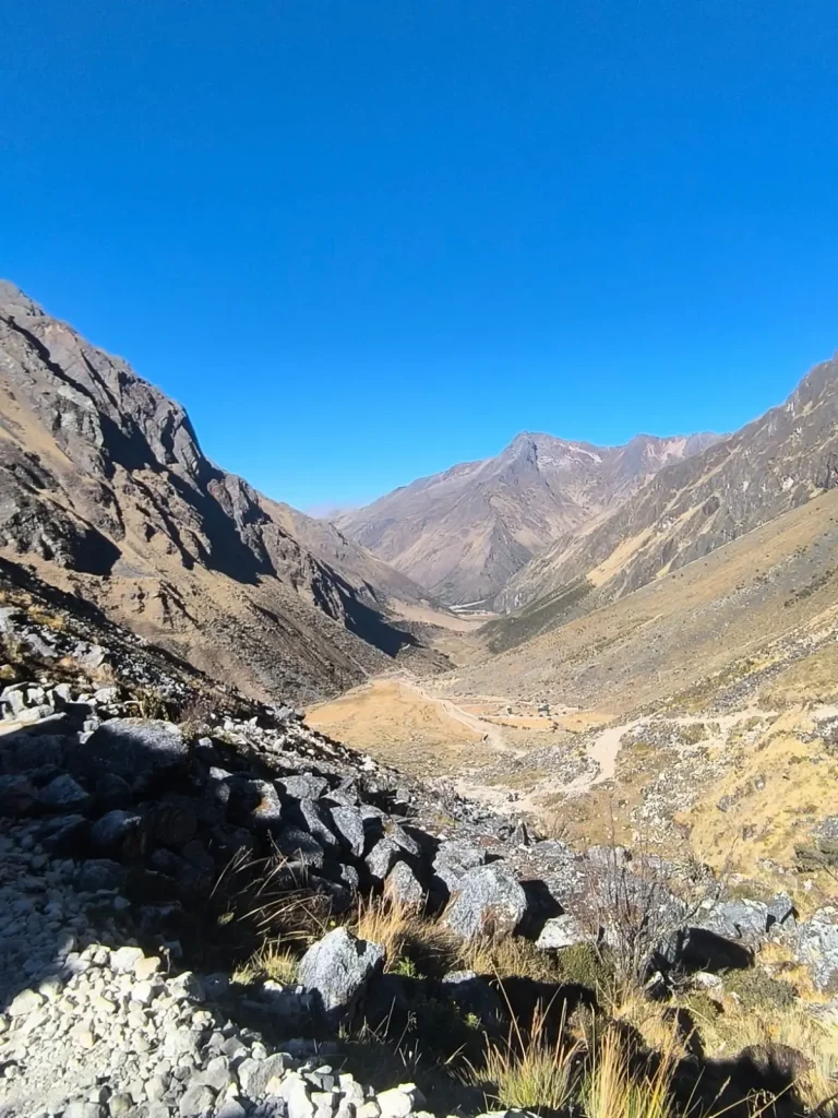 Wide view of a high-Andean valley and winding mountain trail along the Salkantay Trek in Cusco.