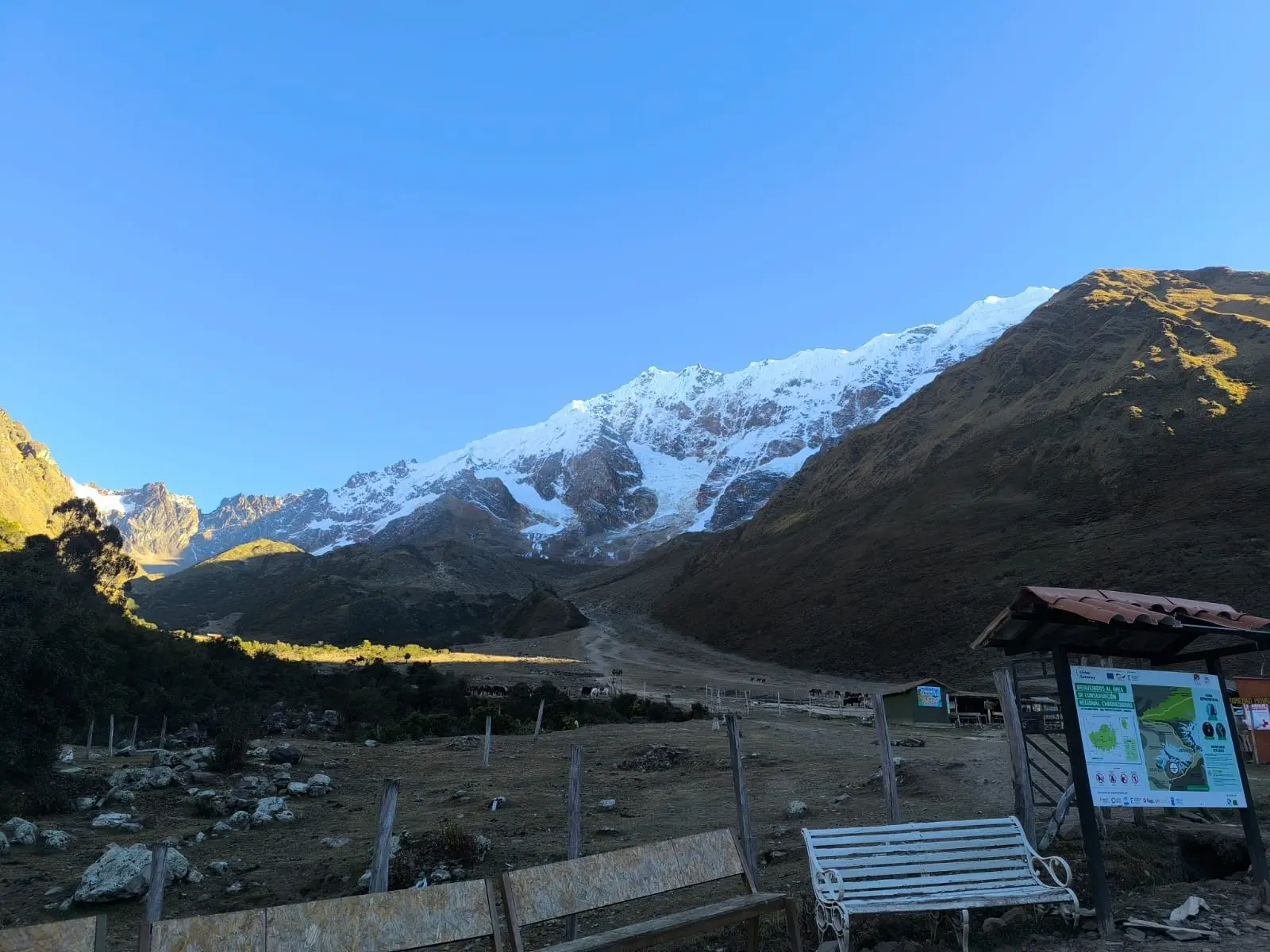 Wide view of the Salkantay mountain range from a trailhead rest area in Cusco, Peru.