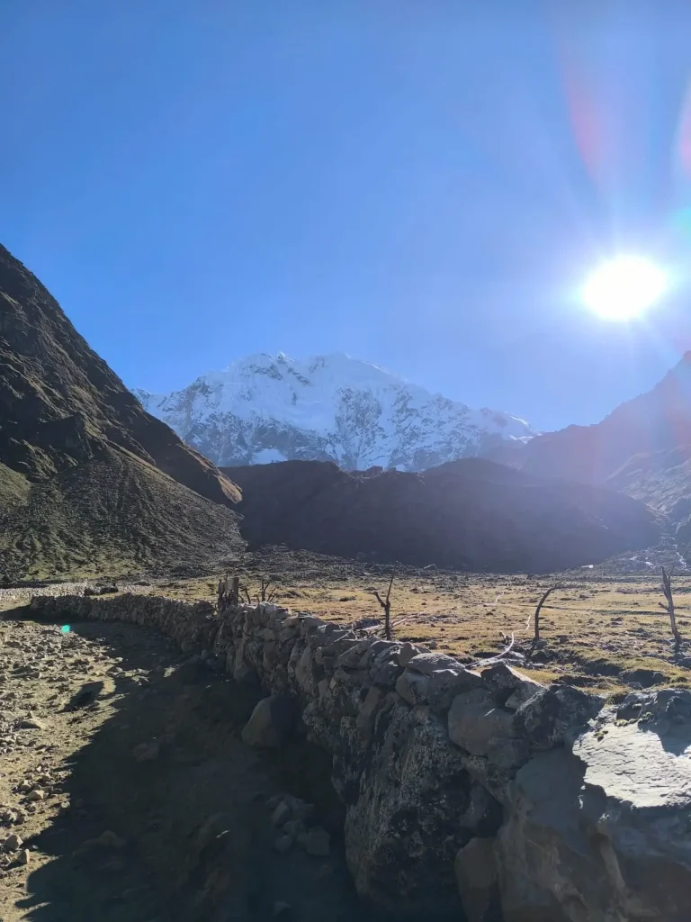 Stone-lined Andean trail leading toward the snow-covered Salkantay Mountain in Cusco, Peru.