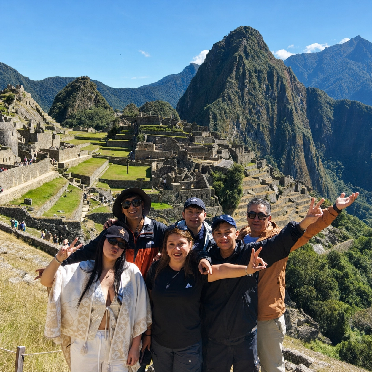 Six travelers posing at Machu Picchu with Huayna Picchu behind them