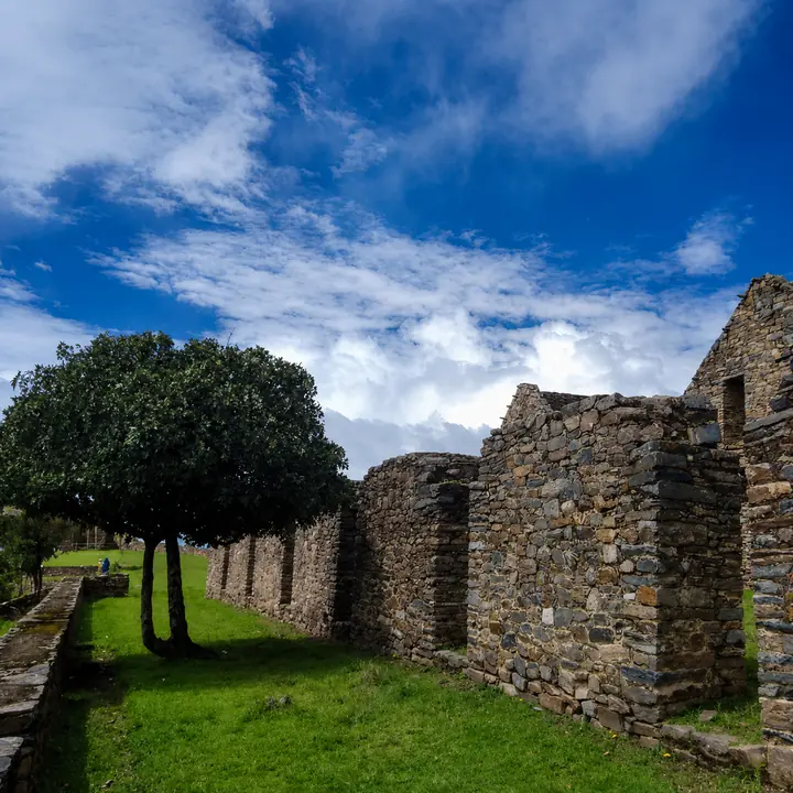 Stone ruins and green courtyards beneath the Andean sky.