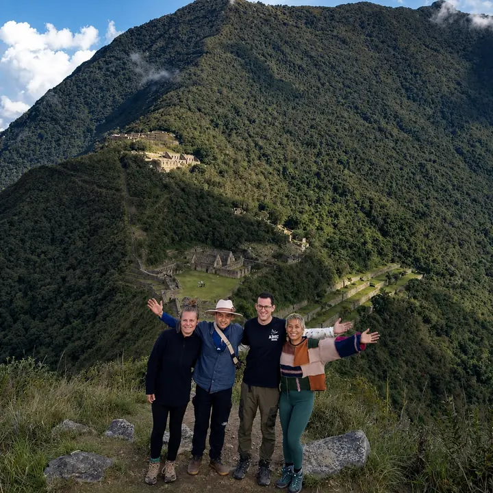 Four travelers overlooking the terraces of Choquequirao.