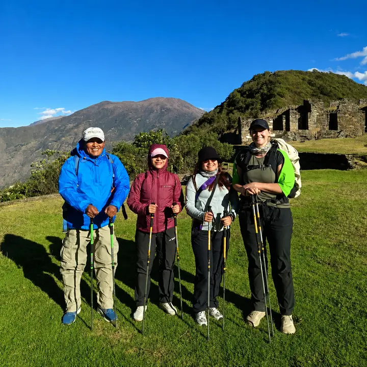 Four hikers standing inside the Choquequirao archaeological site.
