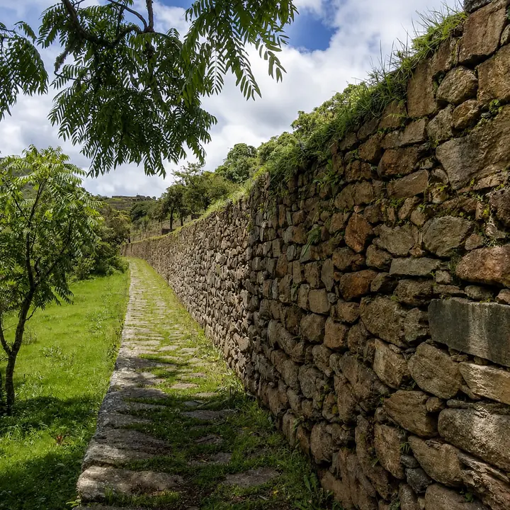 Ancient pathway between stone walls inside Choquequirao.