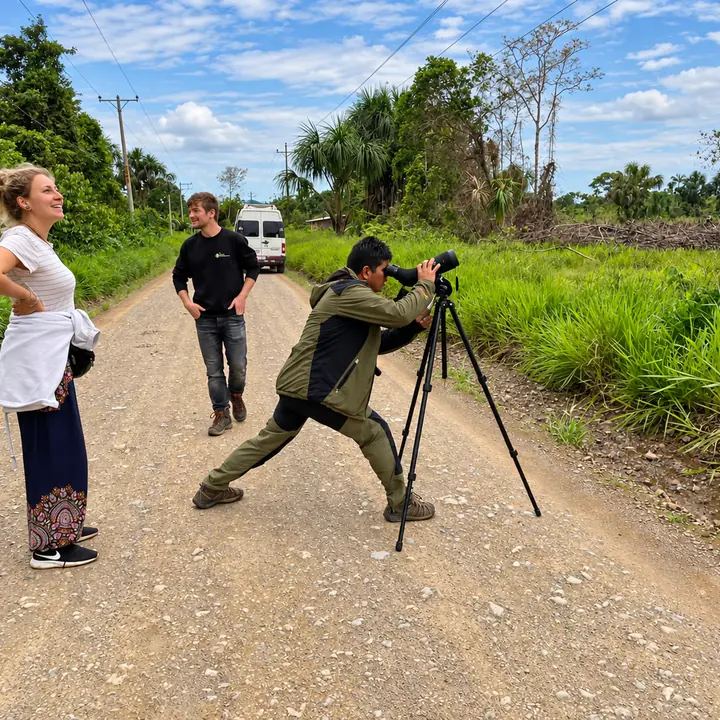 Travelers observing wildlife with a spotting scope in Manu.