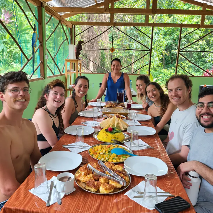Travelers sharing a meal at a rainforest lodge in Manu.