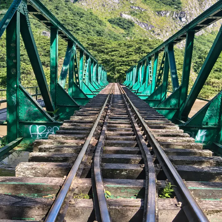 Railway tracks crossing a steel bridge near Hidroelectrica, Peru.