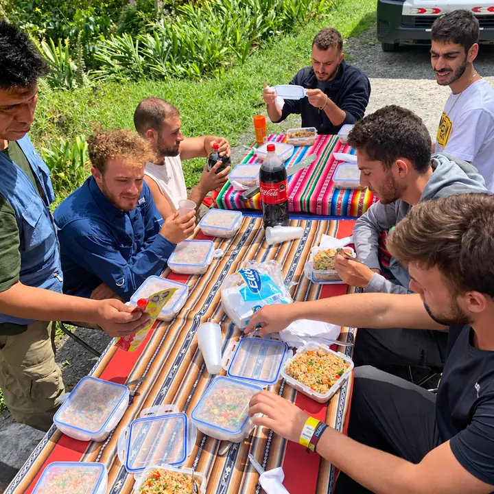 Travelers enjoying an outdoor lunch during a Manu adventure.