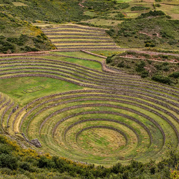 Concentric stone terraces surrounded by grassy hills at Moray.