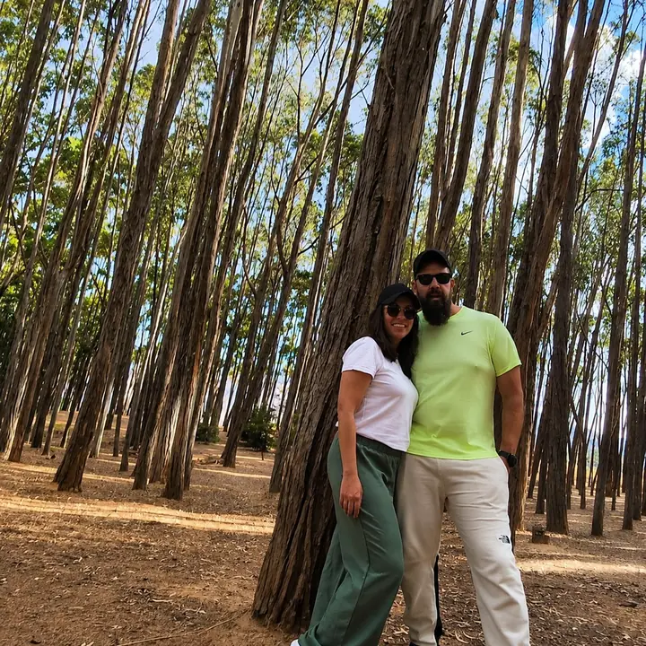 Couple posing among tall eucalyptus trees during a Cusco City Tour.