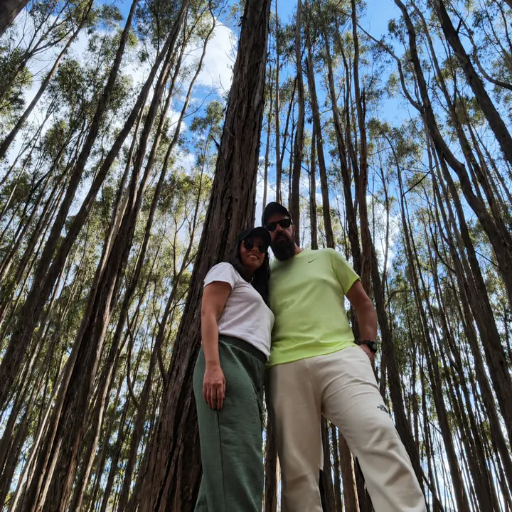 Couple standing beside a eucalyptus tree in the countryside near Cusco.