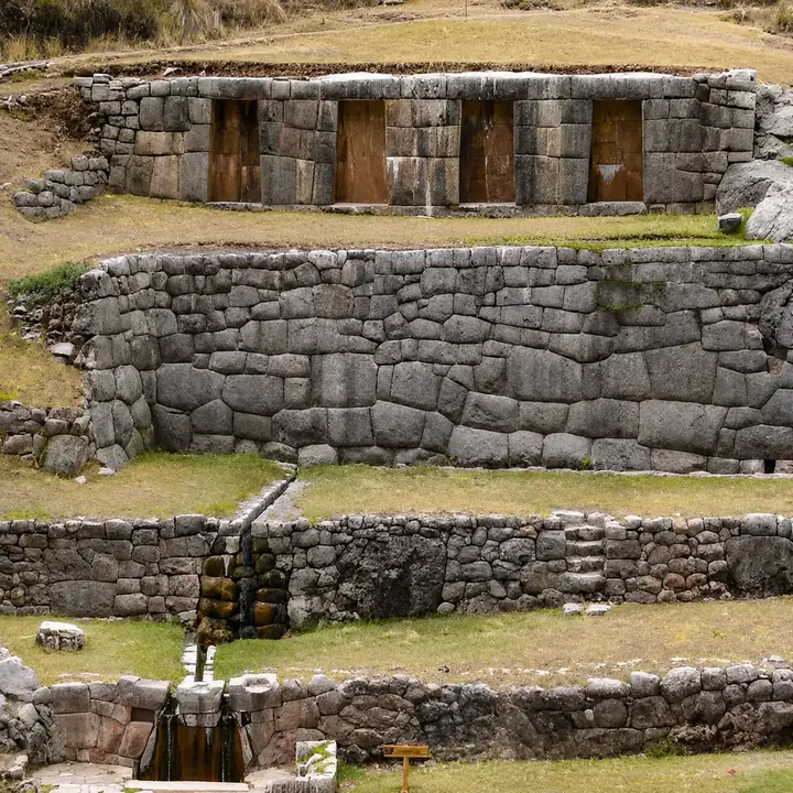 Inca stone terraces and ceremonial water channels at Tambomachay near Cusco.