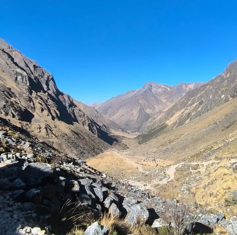 Wide view of a high-Andean valley and winding mountain trail along the Salkantay Trek in Cusco.