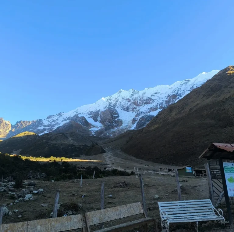 Wide view of the Salkantay mountain range from a trailhead rest area in Cusco, Peru.