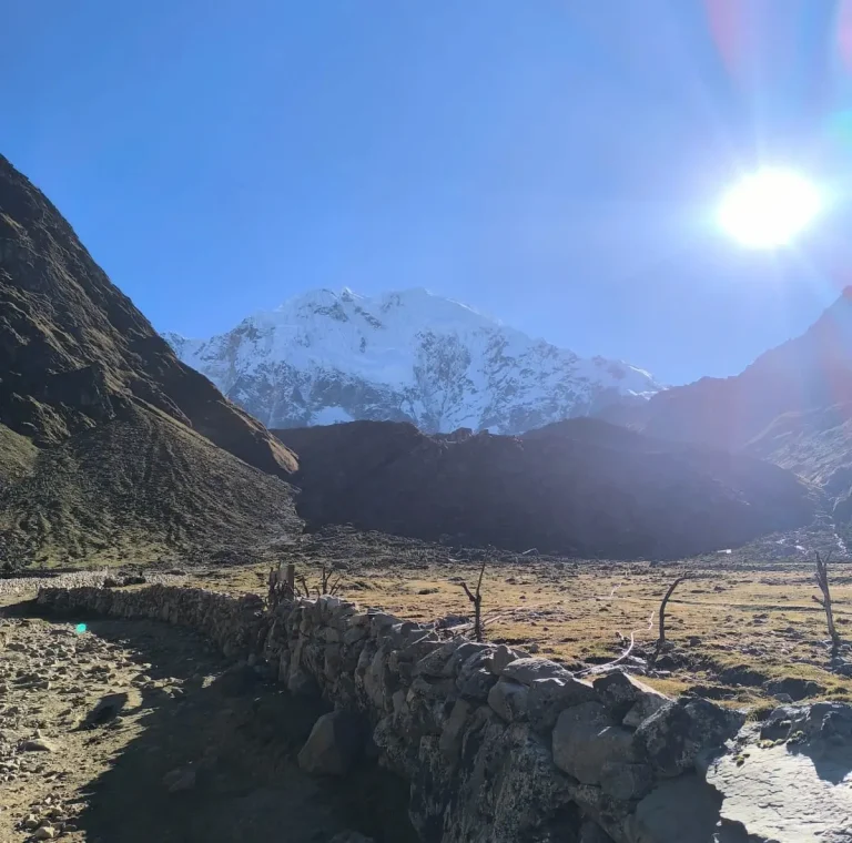 Stone-lined Andean trail leading toward the snow-covered Salkantay Mountain in Cusco, Peru.